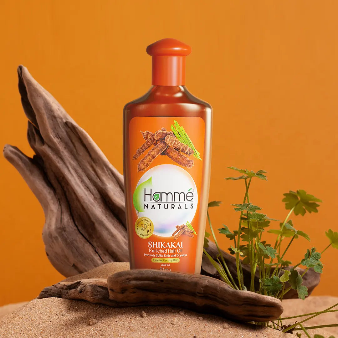 Shikakai Enriched Hair Oil - Hammé - Makes You Stand out - A bottle of Shikakai Oil by Hamme Naturals, featuring orange and cinnamon, enriched with natural hair care ingredients